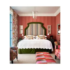 This hotel room is what dreams are made of. The clever play of colours and layering of patterns and textures, from the striped wallpaper to the floral curtains and patchwork furniture, creates a space that is visually stunning.