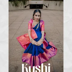 A seated pose from the "Kushi" series, showcasing the beautiful drape and color of the saree. This demonstrates a variety of poses within a single portfolio shoot.