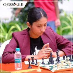 The focused gaze of a competitor. This young player is deeply analyzing the board during a tense moment in the Chess Carnival 2024 tournament.