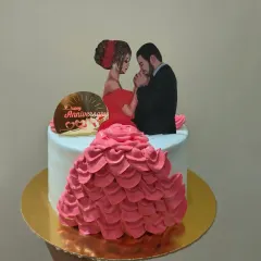 A romantic anniversary cake featuring a beautiful illustration of a couple and an intricate buttercream dress design.