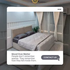 A bedroom's design should evoke a feeling of calm the moment you enter. This space uses a neutral color palette, a soft upholstered headboard, and sheer curtains to create a light and airy atmosphere. It’s a testament to my philosophy that the mood of a room is more memorable than its objects.