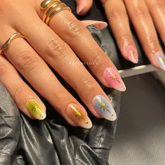 Holding the aura nail set, you can see how the colors complement each other to create a cohesive yet unique look across all ten fingers.