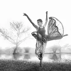 This black and white shot captures the essence of being an explorer through contemporary dance. The dynamic pose and flowing fabric create a powerful image of an artist in motion, fully expressing themselves.