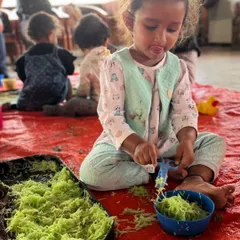 Using child-safe scissors to cut up spaghetti is an excellent way to strengthen hand muscles needed for writing later on. This little one is so focused on the task.