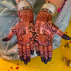 The rich, dark stain of my natural henna is clearly visible in this design. It features beautiful peacock motifs on the palms, surrounded by fine floral and geometric patterns.