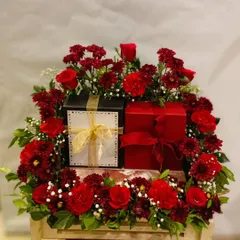 For those truly special occasions, I create luxurious floral hampers that command attention. This arrangement features rich red flowers surrounding premium gift boxes, designed to convey appreciation and high regard.