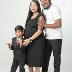 A happy family of three, soon to be four! The older brother is already looking like a cool dude, ready to welcome his new sibling.