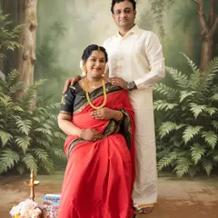 A classic family portrait pose with the couple in traditional South Indian outfits, set against a painted forest backdrop for a timeless feel.
