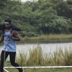 Competing in the Wild Warriors National OCR Championship. This obstacle required carrying a heavy sandbag, a test of pure strength and endurance that my training directly prepares you for.
