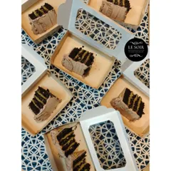 Slices of my Pistachio Kunafa Chocolate Cake, packed and ready for a bakesale. These individual boxes make it easy to grab a slice of this trending dessert.
