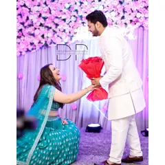 A modern twist on a classic proposal during their engagement ceremony. Her kneeling with a bouquet of red roses for him was a beautiful, heartfelt moment full of joy.