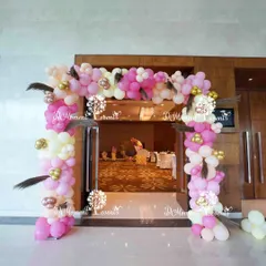 We designed this welcoming entrance arch for a baby's Annaprashan ceremony, marking their first taste of solid food. The boho-themed balloon arch in shades of pink, white, and gold is accented with pampas grass feathers, setting a warm and celebratory tone.