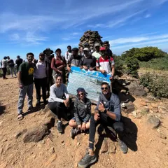 Our group at the Pushpagiri peak marker on the Kumara Parvatha trail. It's a tough climb, and reaching this point is a huge milestone.