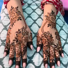 A full view of the matching Arabic floral designs on both hands, showing the beautiful flow of the pattern from the wrist to the fingers.
