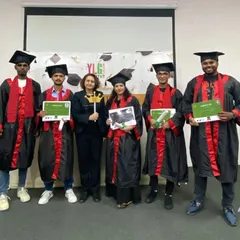 A group of our proud graduates holding their hard-earned certificates. We provide a supportive community that celebrates every milestone on your journey to becoming a professional.