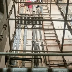 For tall walls, I use proper scaffolding to ensure my team can work safely and efficiently at every height, paying close attention to detail from bottom to top.