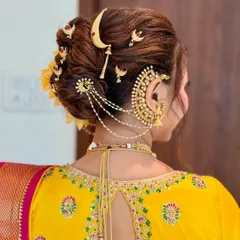 A close-up of the traditional Khopa hairstyle, adorned with a chandrakor and floral accessories. This classic bridal updo is a signature part of my Maharashtrian bridal service.