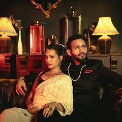A vintage-themed pre-wedding shot, with the couple exuding old-world glamour in a richly decorated, dimly lit room.