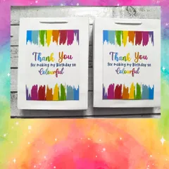 The matching rainbow-themed paper bags, which thank guests for making the birthday "so colourful."