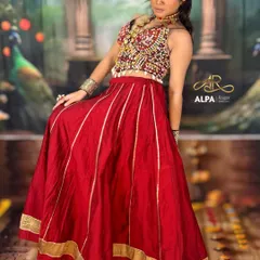 A full-length view of a classic Navratri look. The red ghagra choli is paired with traditional jewelry and makeup that’s both vibrant and elegant.