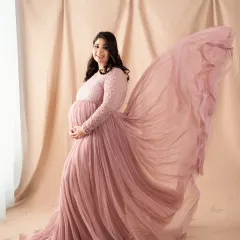 The magic of a flowing gown. We love how the delicate pink fabric catches the air, creating a soft and graceful portrait that is simply breathtaking.