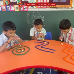 This play-based learning activity combines fun with skill development. Campers use straws to navigate a ball through a play-dough maze, an engaging exercise that strengthens fine motor skills and hand-eye coordination.