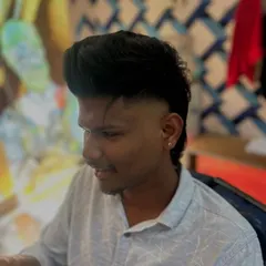 A great side profile of a modern mullet. You can see the sharp fade that separates the voluminous top from the longer hair in the back.