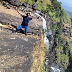 A trekker standing triumphantly at the top of Bandaje Falls. The feeling of being so close to such a powerful force of nature is incredible.