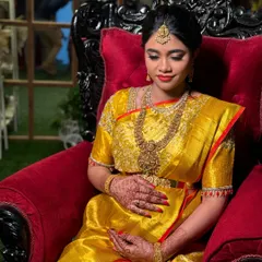 A sweet moment as she holds her baby bump. The vaddanam and layered necklace complete her traditional look for the Valaikappu ceremony.