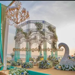 I love bringing dream destination weddings to life. This image captures a stunning glass mandap I designed for a beachside wedding in Goa, combining modern architectural elements with delicate floral work to complement the seaside sunset.