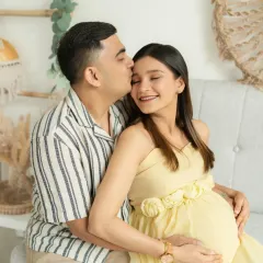 The quiet moments between partners are pure magic. In my natural light studio, I create a relaxed space for you to connect, allowing me to capture the authentic love that surrounds your growing family.