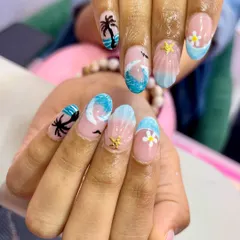 Ready for a getaway with these stunning tropical nails. From the tiny daisies to the waves and dolphin, every detail is perfect for your next beach vacation.