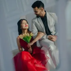 An intimate, romantic shot that focuses on the connection between the couple. The contrast of her red gown and his light suit creates a beautiful visual.