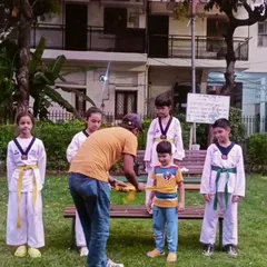 The color belt ceremony is an important tradition. Here, I am awarding a new belt to a deserving student.