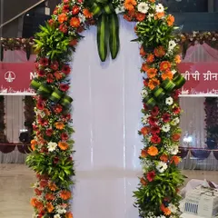 A close-up of one of the floral entrance arches. I used a vibrant mix of orange and white gerberas with intricate green leaf arrangements to create a fresh and welcoming feel for this corporate function.