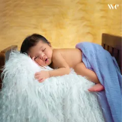 From their little fingers to their tiny toes, we make sure to capture all the details you'll want to remember. This pose highlights the baby's delicate features in a studio setting.