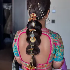 Another look at this intricate bridal braid. The combination of different accessories creates a rich, textured look that is truly a work of art.