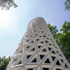 A low-angle view emphasizing the tower's helical, upward twist. This rotation is key to its function, designed through aerodynamic principles to increase surface area and efficiently channel air through its advanced filtration system.