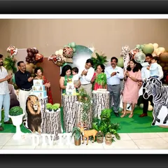 The whole family celebrating a first birthday with my jungle safari theme. Creating the backdrop for these happy memories is what I love to do.