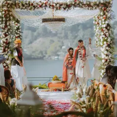 A wide view of a spectacular Hindu wedding mandap set up on the banks of a lake, demonstrating our experience with large-scale destination events.