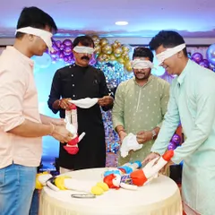 A hilarious blindfolded diaper changing game for the men at a baby shower. It's always a highlight and gets everyone laughing.