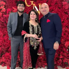 A client looking sharp with his family in a custom-tailored navy bandhgala. True sophistication lies in the details, and this suit was designed with passion for a perfect fit.