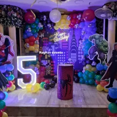 A closer look at the superhero birthday stage decoration. You can see the detailed balloon work, character cutouts, and the glowing number '5' that make the setup exciting for kids.