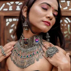A close-up of a multi-colored oxidised choker with coin details. This piece is perfect for adding a bohemian touch to any festive outfit.