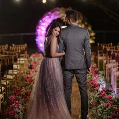 A romantic portrait of the couple in their beautifully decorated aisle. The pink floral arrangements and warm lighting create an enchanting atmosphere for their engagement photos.