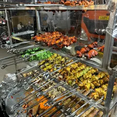 Our tandoor station in full swing, showcasing a colorful variety of freshly grilled kebabs. You can see skewers of Malai Tikka, Hariyali Tikka, and classic Tandoori Tikka, all ready to be served hot and smoky.