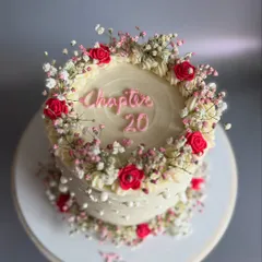 A top-down view of the 'Chapter 20' cake, showcasing the beautiful floral wreath design. This style is perfect for sweet 16s, 18ths, and 20th birthdays.