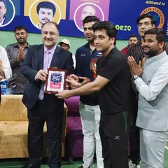 Head Coach Ravindra Singh receiving a plaque in recognition of his performance and victory at the Agra Badminton Premier League. We are proud to have such accomplished leaders guiding our students.