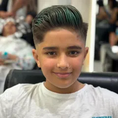 A young client looking sharp with his new fade haircut and creative green color. This look is all about confidence and expressing personal style at any age.