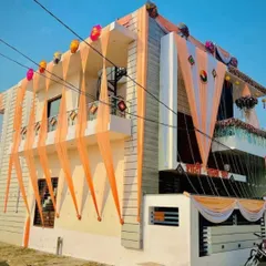 A full view of a house exterior decorated for a wedding celebration. The facade is adorned with flowing peach and white drapes, creating a grand and welcoming entrance for guests. This type of home wedding decoration sets a festive tone for the entire neighborhood.